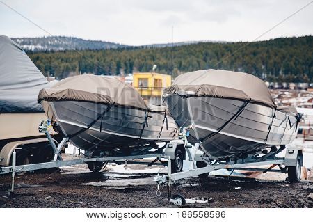 shrink wrapped power boat in autumn woods