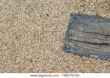 Texture Of Small Pebbles And An Old Board