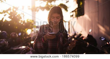 young stylish happy hipster woman traveling around the world wearing aviator sunglasses, denim shirt, tropical island lagoon vacation.