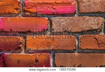 Brick wall background with many different shades of red and pink