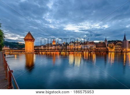 Night view towards Chapel Bridge (Kapellbruecke) together with the octagonal tall tower (Wasserturm) it is one of the Lucerne's most famous tourists attraction
