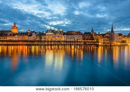Night view towards Chapel Bridge (Kapellbruecke) together with the octagonal tall tower (Wasserturm) it is one of the Lucerne's most famous tourists attraction