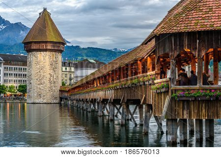 Night view towards Chapel Bridge (Kapellbruecke) together with the octagonal tall tower (Wasserturm) it is one of the Lucerne's most famous tourists attraction