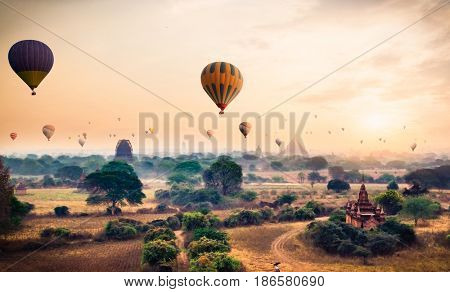 Hot air balloon over plain of Bagan in misty morning, Myanmar. (Burma)