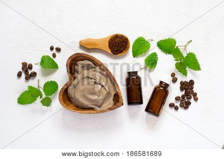 Spa setting with cosmetic clay mask for body, Towel  Essential oil and coffee beans