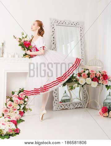 Pretty ballerina in stage costume holding a bouquet of spring flowers. Retro dress. She is dancing