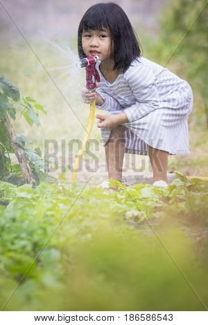 little asian children playing in home garden