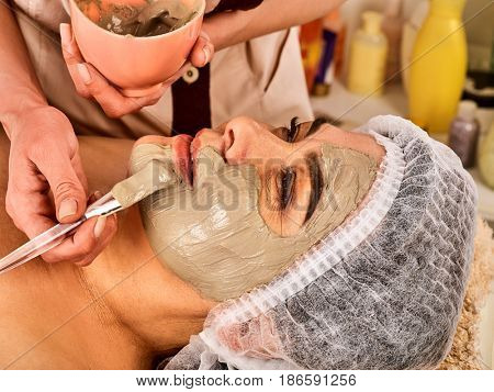 Collagen face mask. Facial skin treatment. Face of woman of elderly woman 50-60 years old receiving cosmetic procedure in beauty salon close up . Professional cosmetologist.