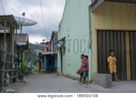 BERASTAGI INDONESIA 15 MAY 2017 : Three indonesian children on the street at countryside area of Berastagi city Northern Sumatra.