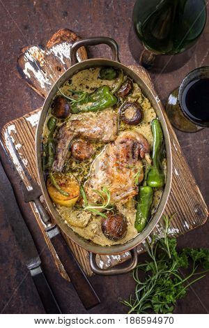 Rabbit with Vegetable and Mushrooms in White Wine Cream Sauce as top view in a Stewpot 