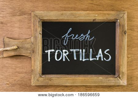 Chack board with Fresh Tortillas sign .