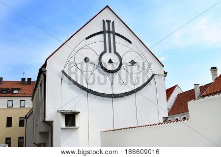 Sundial on building. Kaunas, Lithuania - May 15, 2017: Sundial: A Smiling City Symbol. The ever-happy sundial in the Old Town of Kaunas was installed in 1986 on the wall of Vilnius University.