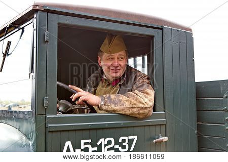 Yekaterinburg, Russia - 8 May, 2017: The driver of the times of the Great Patriotic War the behind the wheel of a truck GAZ-AA (polutorka). Victory Day.
