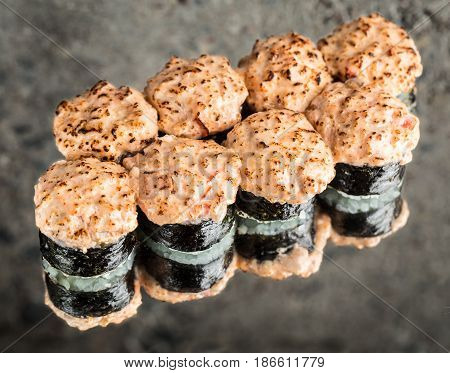Sushi roll with salmon over cocnrete background