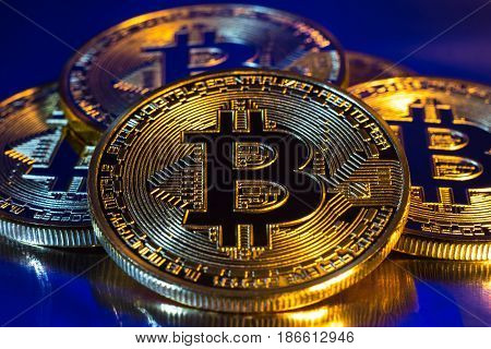 Photo of cryptocurrency physical golden bitcoin coin on colorful background