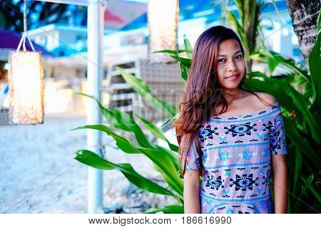 Attractive beautiful asian girl with long hair posing on the beach during the night