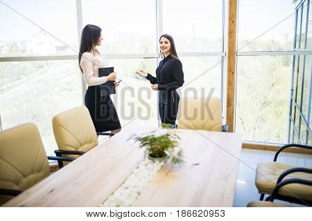 Two Beauty Businesswomen Having Informal Meeting In Modern Office