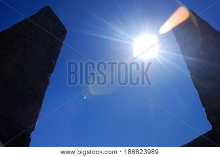 Sun shining between two pillars at Maryhill Stonehenge in Washington USA