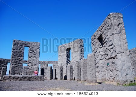 Tourist examines a pillar at the Maryhill Stonehenge at Maryhill, Washington