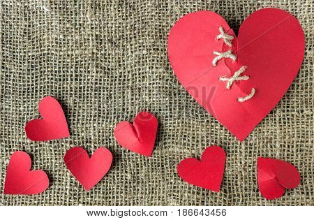 A broken red heart. Sewn thread. The concept of divorce separation quarrel.