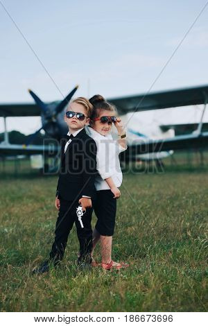 photo of young boy and girl playing spy