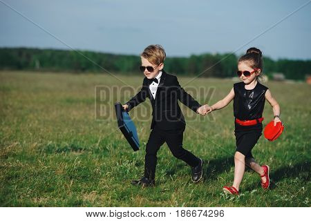 photo of young boy and girl playing spy