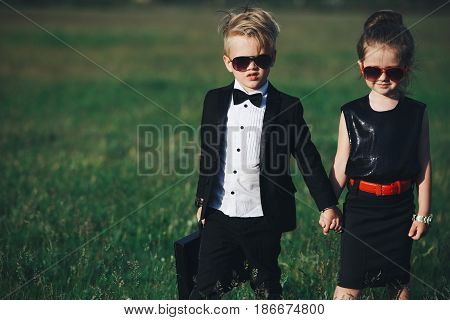 photo of young boy and girl playing spy