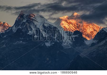 Beautiful first light from sunrise on Mount Kanchenjugha Himalayan mountain range Sikkim India. Orange tint on the mountains at dawn