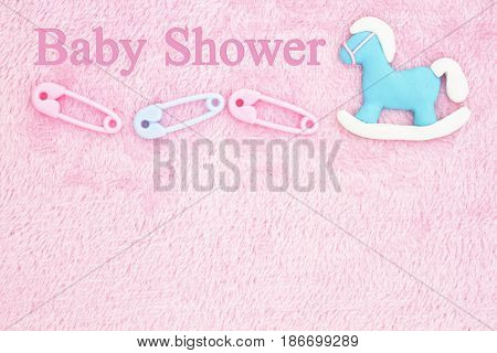 Old fashion pink baby shower background with baby diaper pins and a rocking horse with text Baby Shower