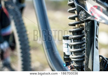 Suspension elements of the mtb bike of a two-pendant mountain bike close-up spring and shock absorber