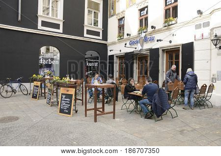 GRAZ, AUSTRIA - MARCH 19, 2017: People at outdoor restaurant on Glockenspielplatz square in Graz the capital of federal state of Styria Austria.
