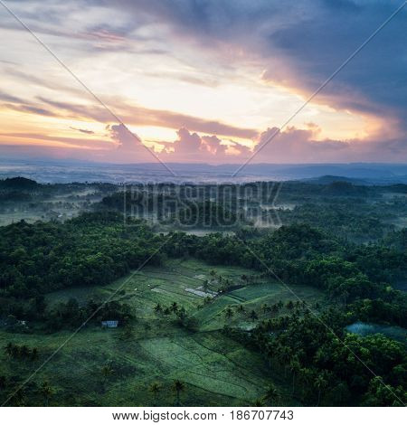 Aerial view of landscape with mist in morning light. Bohol, Philippines 2017.