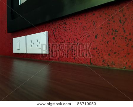 White plugs and power switch on red wall,Industry building construction Home electrical switch and plug on wall