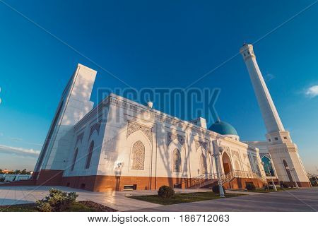 A big beautiful Mosque (Islamic temple) at sunset over blue sky wide angle photo