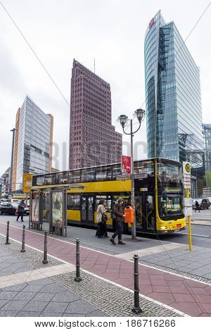 BERLIN GERMANY - APRIL 7: Yellow sightseeing bus at Potsdamer platz on April 7 2017 in Berlin