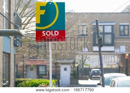 Estate Agency Sold Sign Outside A English Townhouse