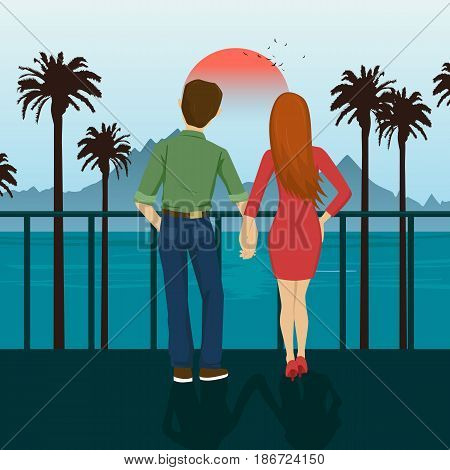 Young couple holding hands standing on the seafront, looking at sunset. Mountains, sea, ocean, palm trees, seacoast