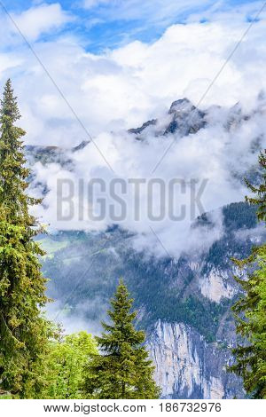 The Swiss Alps at Murren, Switzerland. Jungfrau Region. Tops of the mountains in fog and clouds.