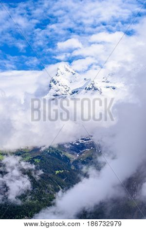The Swiss Alps at Murren, Switzerland. Jungfrau Region. Tops of the mountains in fog and clouds.
