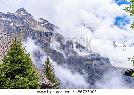 The Swiss Alps at Murren, Switzerland. Jungfrau Region. Tops of the mountains in fog and clouds.
