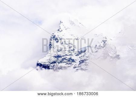 The Swiss Alps at Murren, Switzerland. Jungfrau Region. Tops of the mountains in fog and clouds.