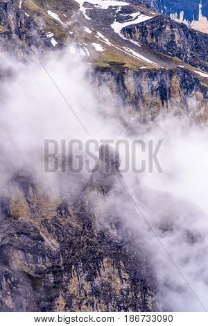 The Swiss Alps at Murren, Switzerland. Jungfrau Region. Tops of the mountains in fog and clouds.