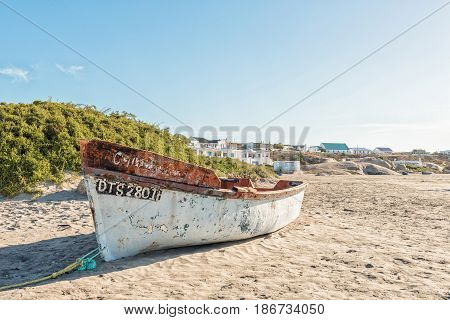 PATERNOSTER SOUTH AFRICA - APRIL 1 2017: View of a fishing boat and houses at a beach in Paternoster a small town in the Western Cape Province