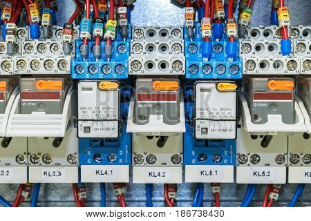 Some electrical relay is mounted on the mounting panel. Relays inserted in the base or socket. To the relay wires connected with the terminals and marking.