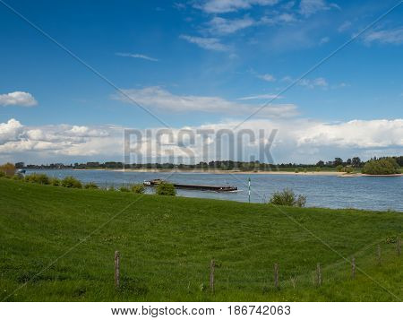 Ship drives the Rhine upstream Grieth Kalkar Germany