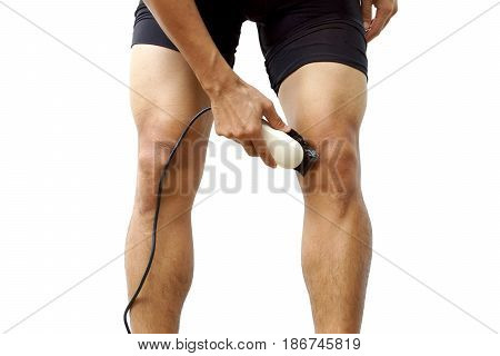 A professional cyclist shaving his legs using hair clipper for improving aerodynamics isolated