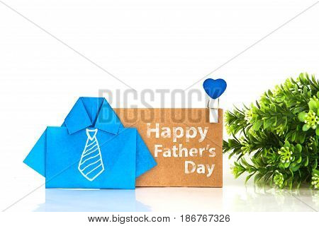 blue origami shirt paper with white hand drawing necktie and Happy Father's day message on brown paper tag creative Father's day decoration concept