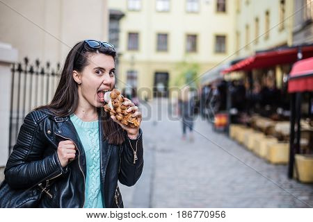 woman eat icecream oustide wile walking the city