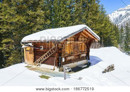small wooden traditional alpine cabin in the mountains of the Switzerland Alps Switzerland.