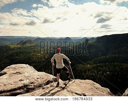 Happy Man With Broken Leg In Immobilizer And Medicine Pole Stay Finnaly On  Peak.